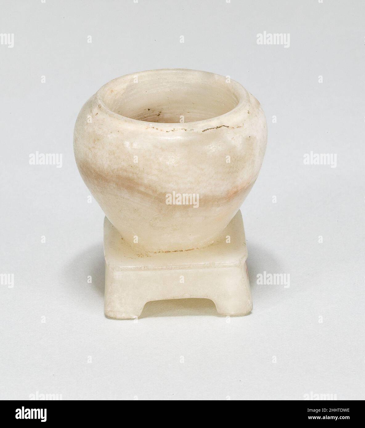 Jar for Eye Paint (kohl) with Attached Stand ca. 1850–1775 B.C. Middle Kingdom. Jar for Eye Paint (kohl) with Attached Stand. ca. 1850–1775 B.C.. Travertine (Egyptian alabaster). Middle Kingdom. From Egypt. Dynasty 12–13 Stock Photo
