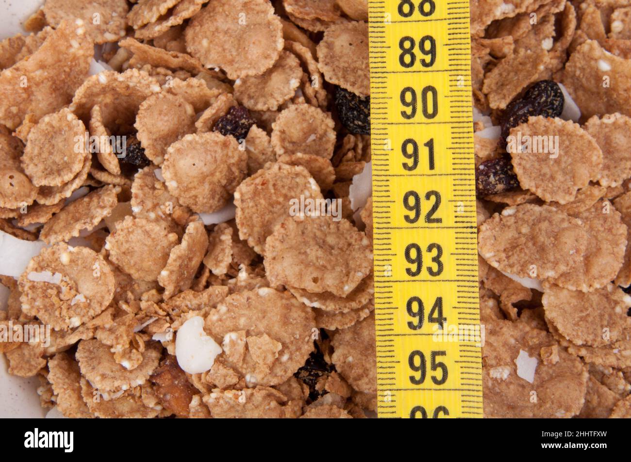 organic cereal in beige bowl with tape measure Diet food. Stock Photo