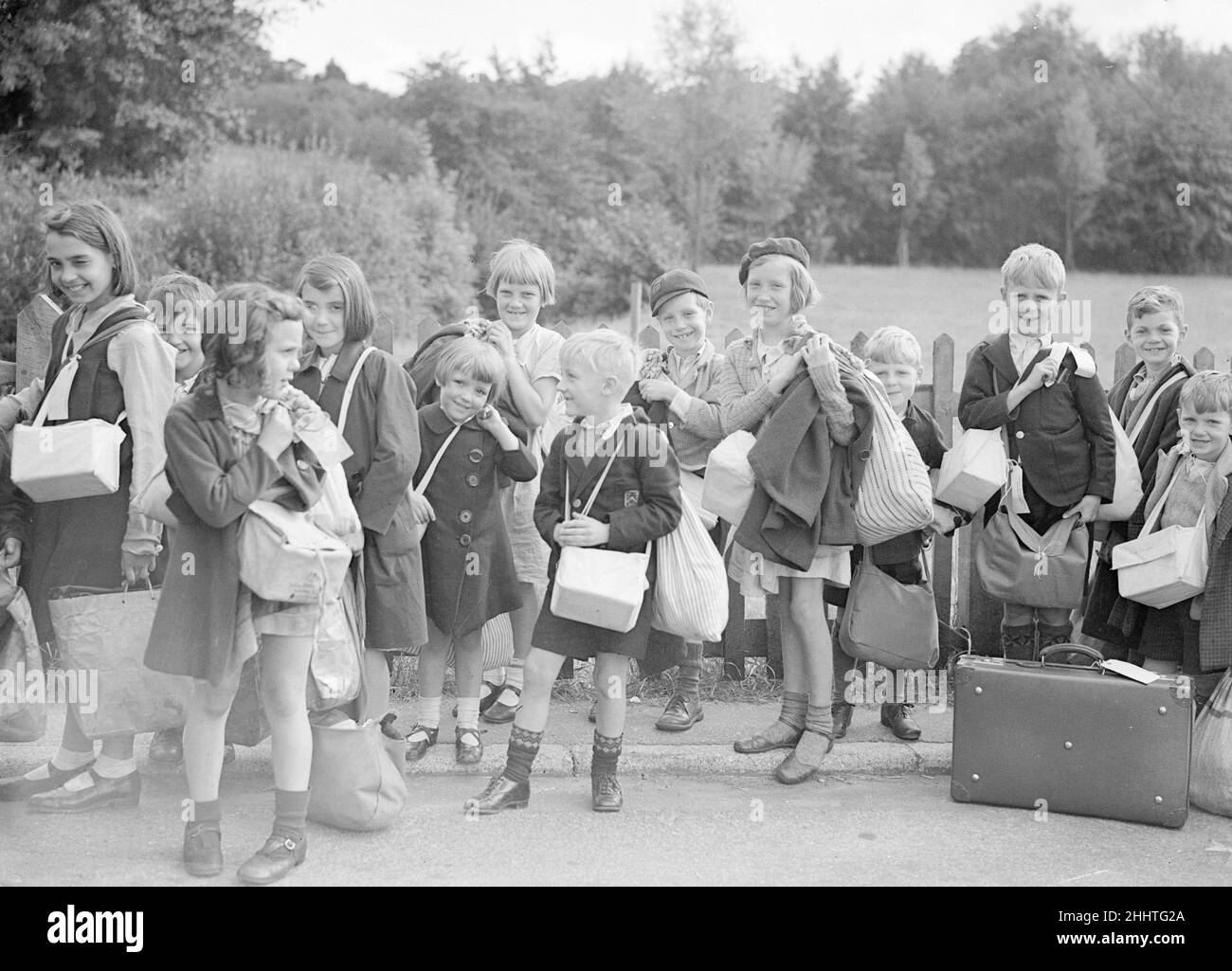 Evacuations of civilians in Britain during World War II was designed to save the population of urban or military areas from German aerial bombing of cities and military targets such as docks. Children, were moved to rural areas thought to be less at risk. Operation Pied Piper started on the 1st September and  went on to the 3rd September 1939. More than 1.5 million people were evacuated. Further waves of official evacuation and re-evacuation occurred from the south and east coast in June 1940, when a seaborne invasion was expected, and from affected cities after the Blitz began in September 19 Stock Photo