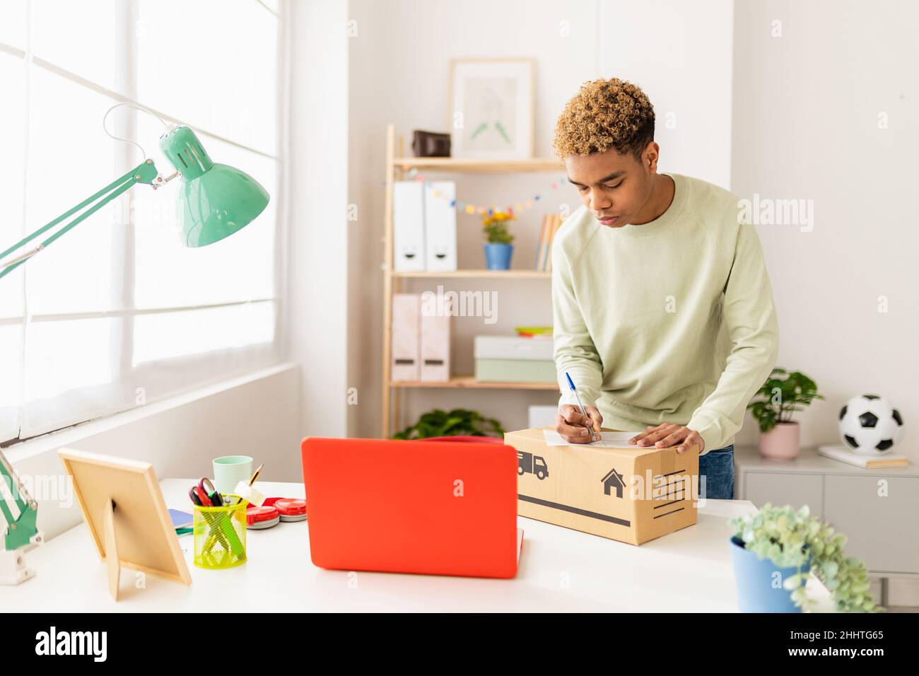 Young seller man preparing second hand package before send to buyer Stock Photo