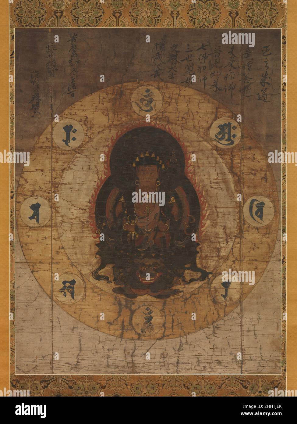 Monju Bosatsu with Eight Sacred Sanskrit Syllables mid- to late 14th century Japan Monju (Sanskrit: Manjushri), the Bodhisattva of Wisdom, is seated on a lion against an ovoid nimbus edged with flames. He wears a crown decorated with eight miniature Buddhas and holds a sword and a long stemmed lotus flower supporting a vajra—a pronged implement with origins in Indian weaponry. In other manifestations of the bodhisattva, Monju’s lotus typically supports a Buddhist scripture, but here the vajra is an emblem of wisdom. Monju is surrounded by eight Sanskrit seed syllables, or sacred utterances sym Stock Photo