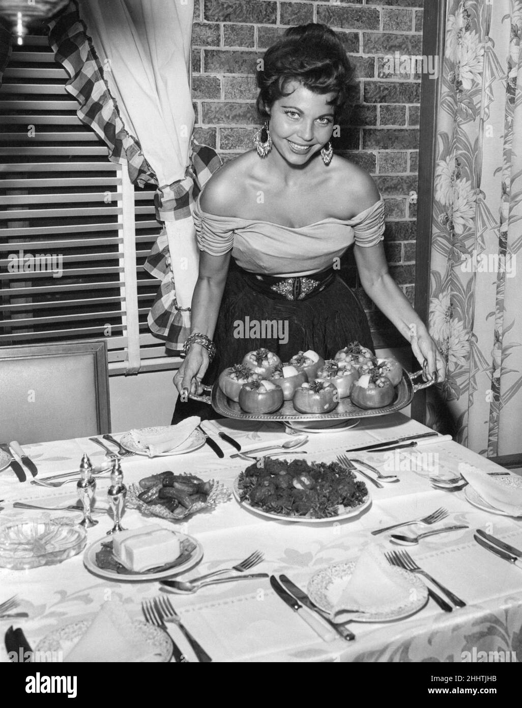 Simone Silva, french actress show how to create the perfect dinner party meal, London, July 1955. Published in Reveille magazine 01/07/1955. Stock Photo