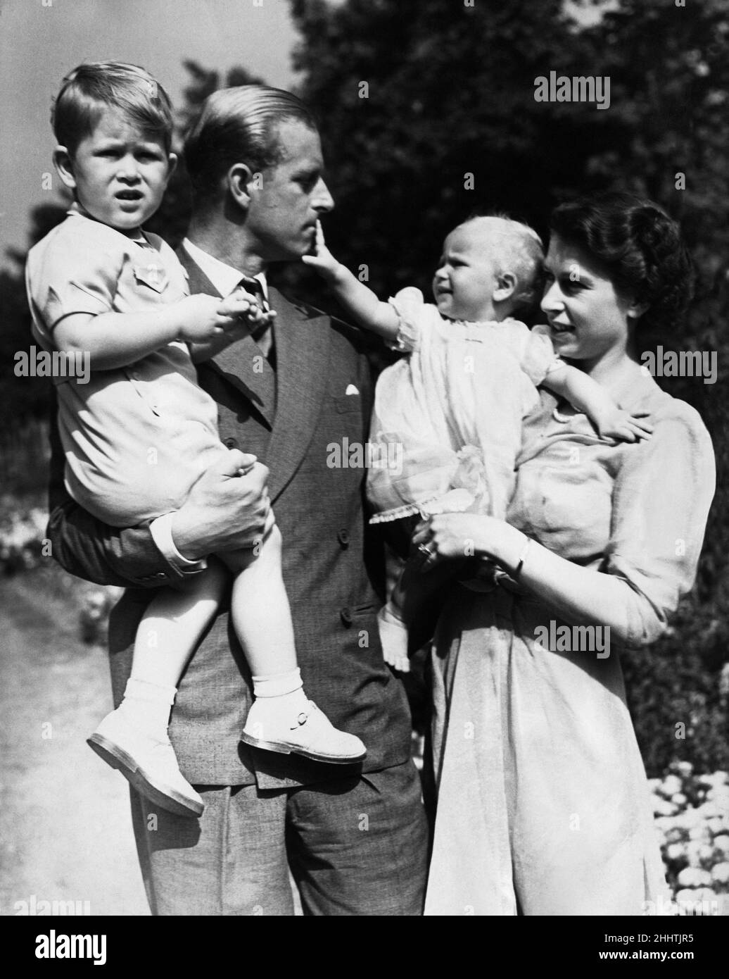 Queen Elizabeth II And Her Husband Prince Philip With Their Two 
