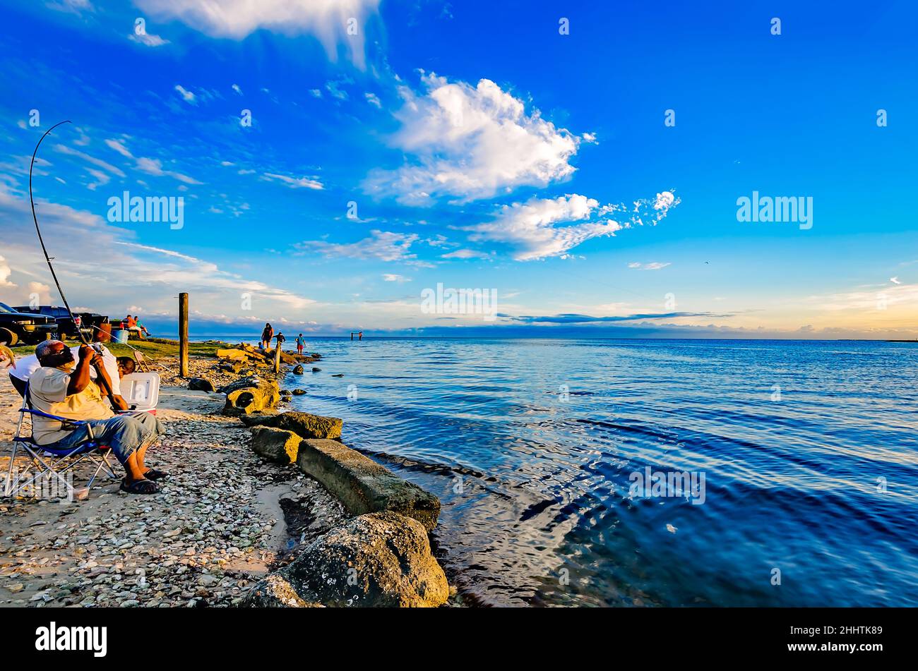 A man fishes at the Bayou La Batre State Docks, Aug. 15, 2015, in Bayou La Batre, Alabama. The spot is a popular afternoon location for locals. Stock Photo