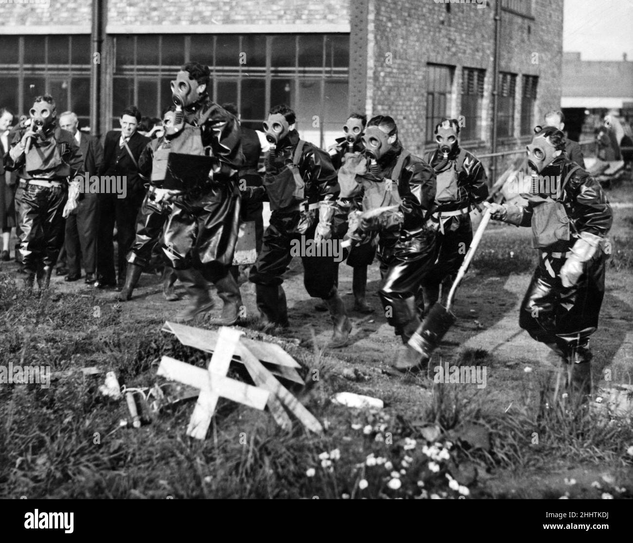 No official caption. ARP Personnel training in bomb disposal and decontamination. They are wearing the full anti-gas suit with civilian service respirator.  1938. Stock Photo