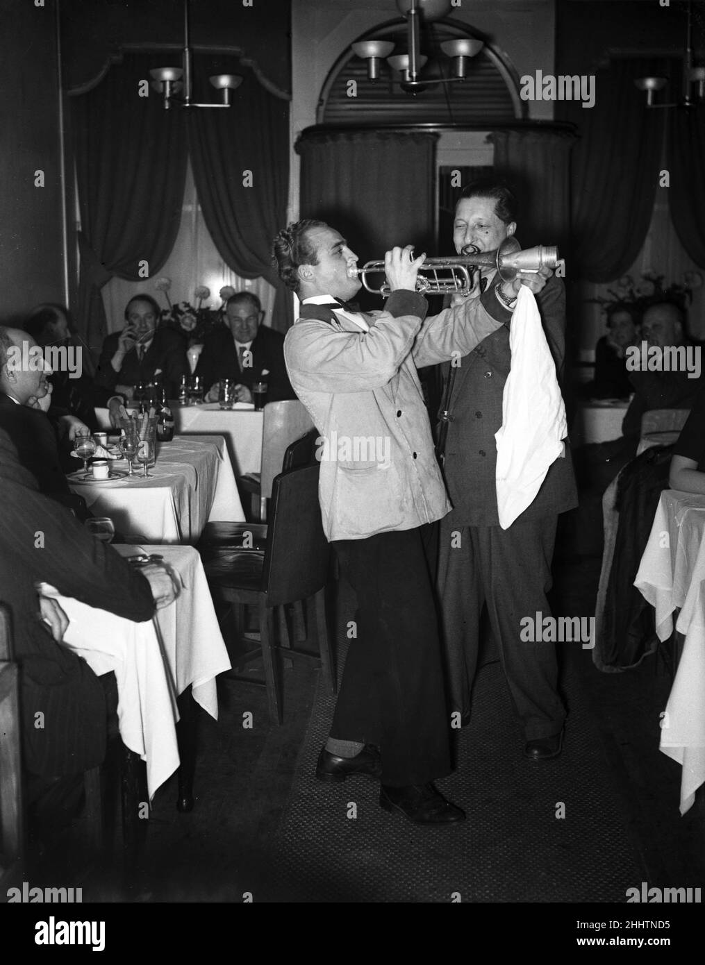 Scenes at Cafe Bleu restaurant in Soho, London. Musicians playing to customers seated at their tables. 1st November 1951. Stock Photo