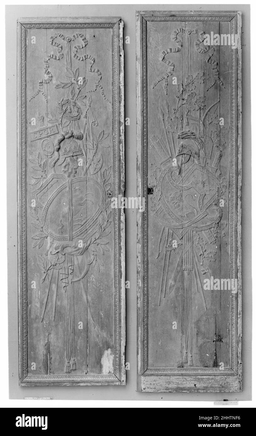 Panel with trophy representing Africa ca. 1780–85 French The panels are each carved with a trophy comprising arms and armor suspended from a tasseled ribbon: in antiquity, military victories were commemorated with a display of arms captured from enemy troops and hung on a tree or temple. Oak branches are added to the martial symbols on 07.225.100a. Laurel branches, a laurel wreath and a standard with SPQR (short for Senatus Populusque Romanus or the Senate and the Roman People) above a portrait of a Roman emperor or general are added to the arms and armor on 07.225.100b. The shield with the ho Stock Photo