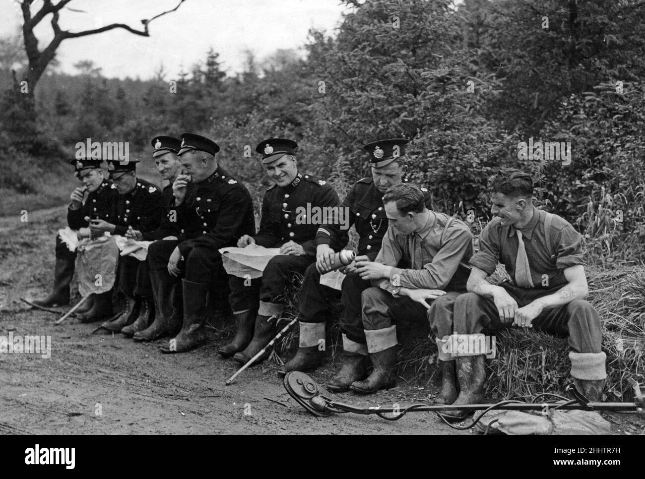 Glamorgan police and men of the 169th Bomb Disposal Unit make a break for a meal during their search with mine detector for a second weapon believed to have been use by Muriel Joan Drinkwater's assailant. July 1946. Stock Photo