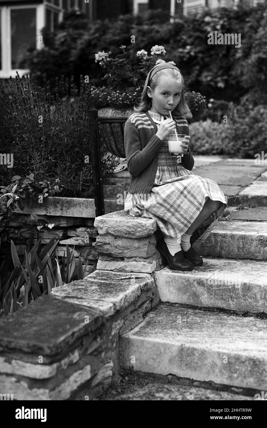 Actress Juliet Mills drinking milk at home. 17th August 1951. Stock Photo