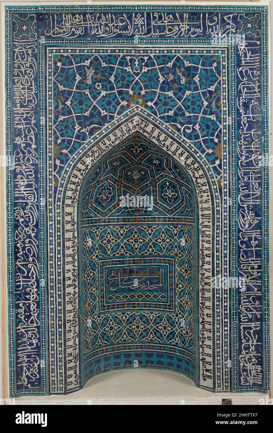 Mihrab (Prayer Niche) dated A.H. 755/ A.D. 1354–55 The most important element in any mosque is the mihrab, the niche that indicates the direction of Mecca, the Muslim holy pilgrimage site in Arabia, which Muslims face when praying. This example from the Madrasa Imami in Isfahan is composed of a mosaic of small glazed tiles fitted together to form various patterns and inscriptions. Qur'anic verses run from the bottom right to the bottom left of the outer frame; a second inscription with sayings of the Prophet, in Kufic script, borders the pointed arch of the niche; and a third inscription, in c Stock Photo