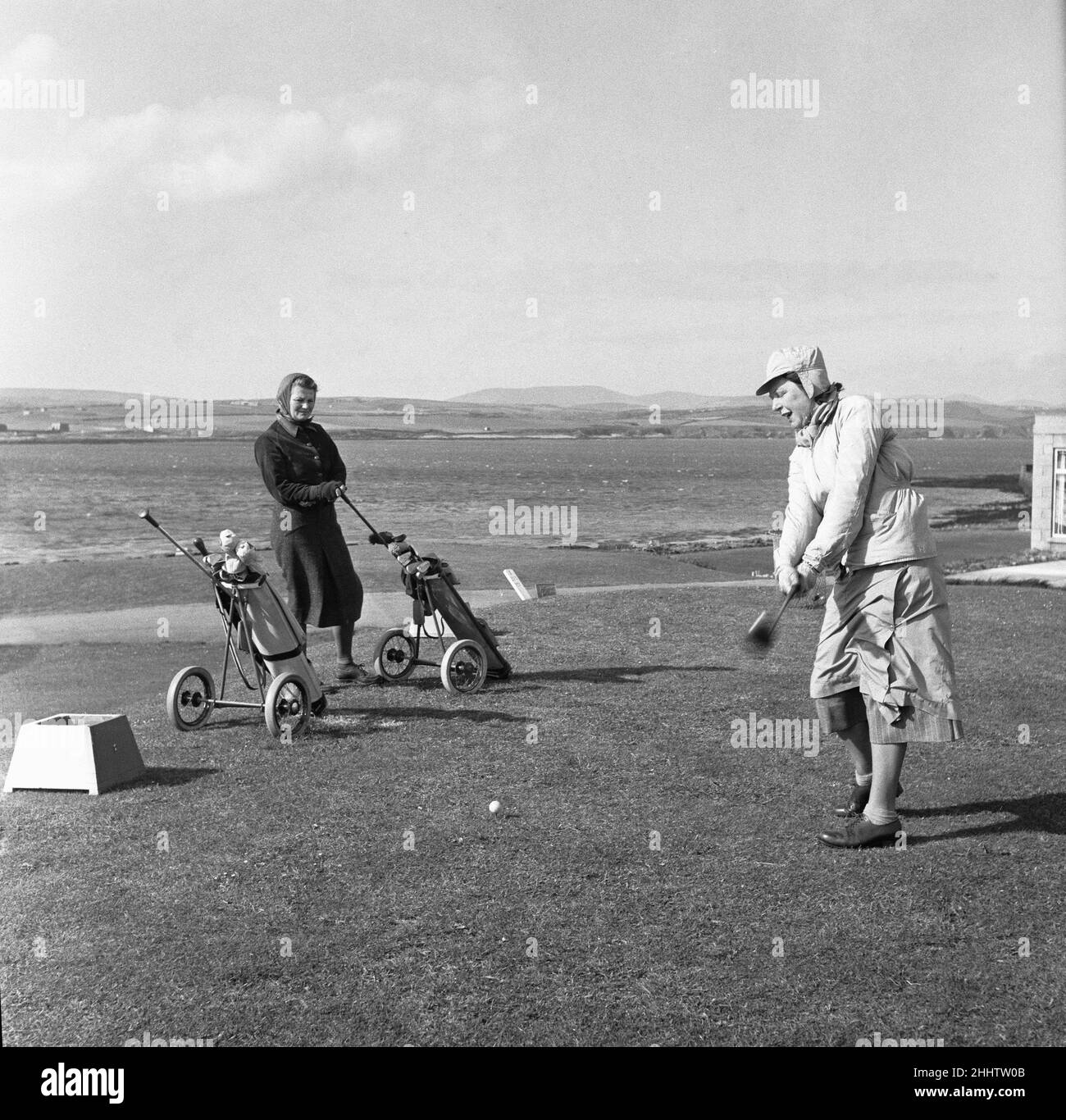 Women playing a round of golf on a very windy Fort Island Golf links