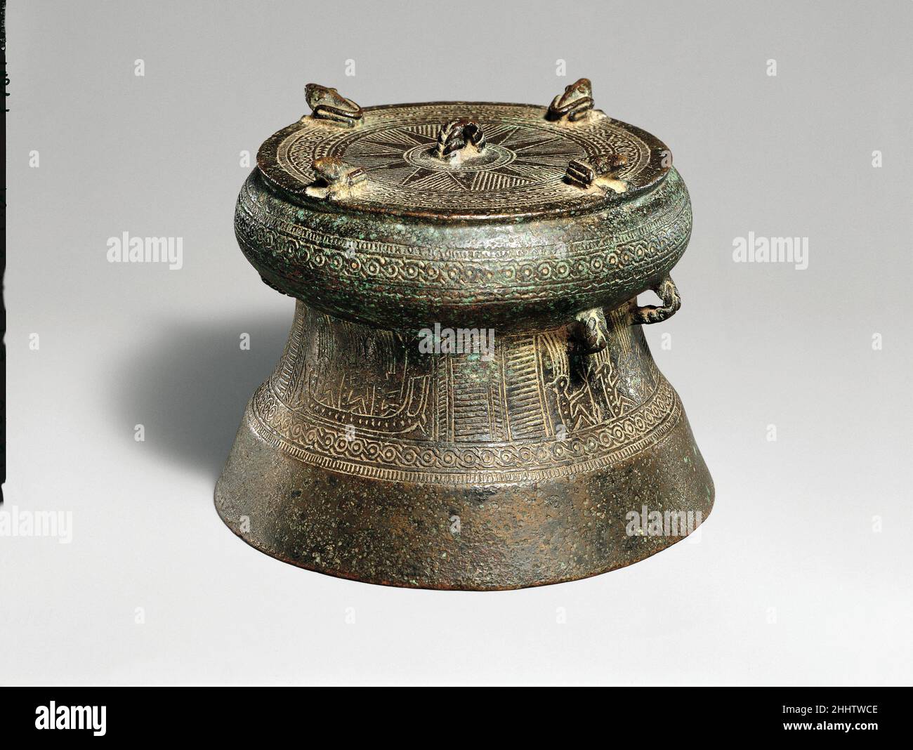 Miniature Drum with Four Frogs ca. 500 B.C.–A.D. 300 Vietnam Ranging in height from a few inches to over six feet, up to four feet in diameter, and often of considerable weight, drums are the most widely dispersed products of the Dongson culture of northern Vietnam. Examples produced in Vietnam, in addition to works made locally, have been found in south China and throughout mainland and island Southeast Asia. The function of these drums, often found in burials, remains unclear. They may have been used in warfare, as political regalia, or as part of funerary and other ceremonial rites.. Miniat Stock Photo