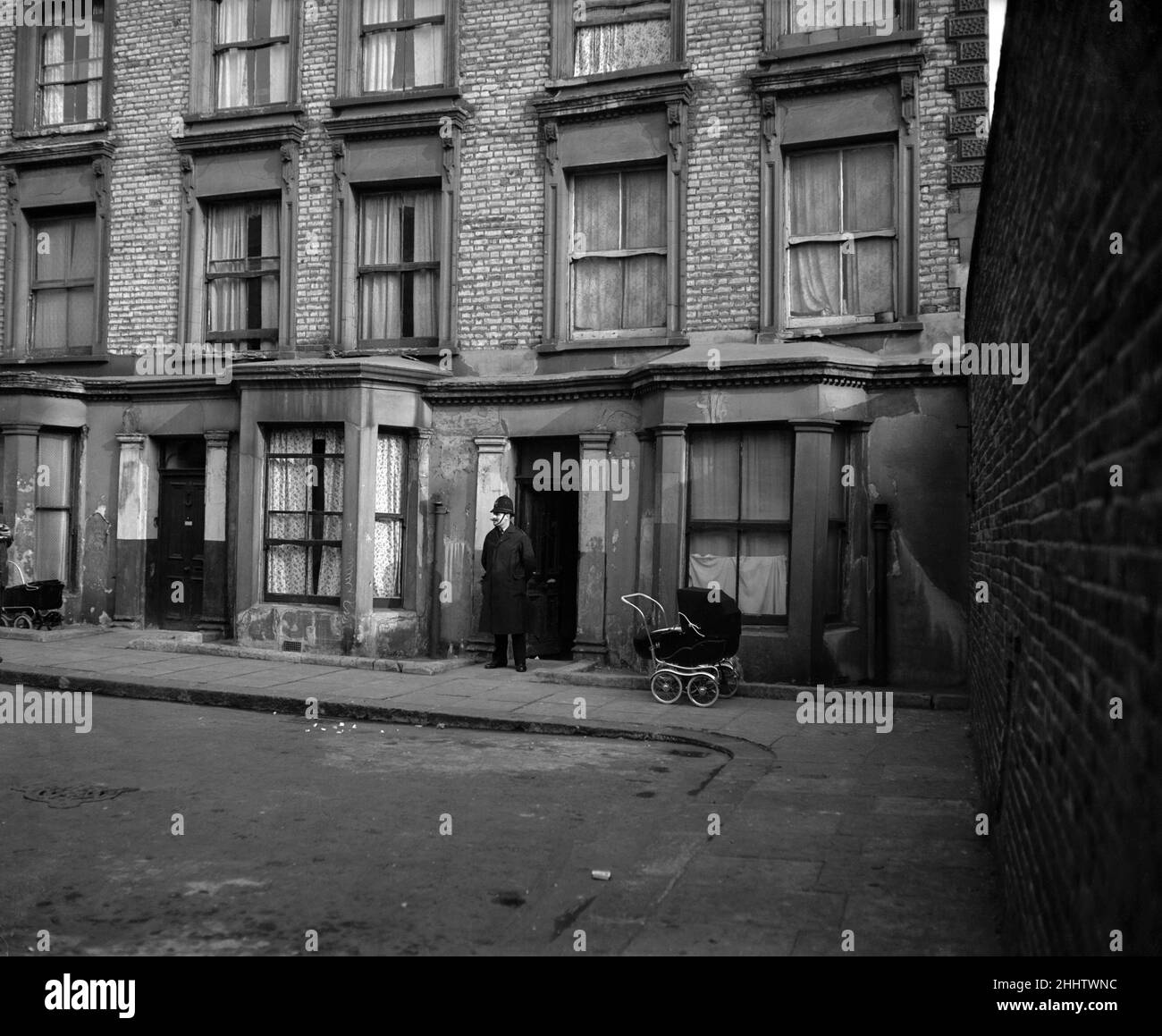 A general view of Rillington Place in west London where at Number 10 the bodies of four women were found. It was in this house that John Christie had lived and moved out of during March 1953, soon afterward the bodies of three of his victims were discovered hidden in an alcove in the kitchen. His wife's body was found beneath the floorboards of the front room. 25th March 1953. Stock Photo