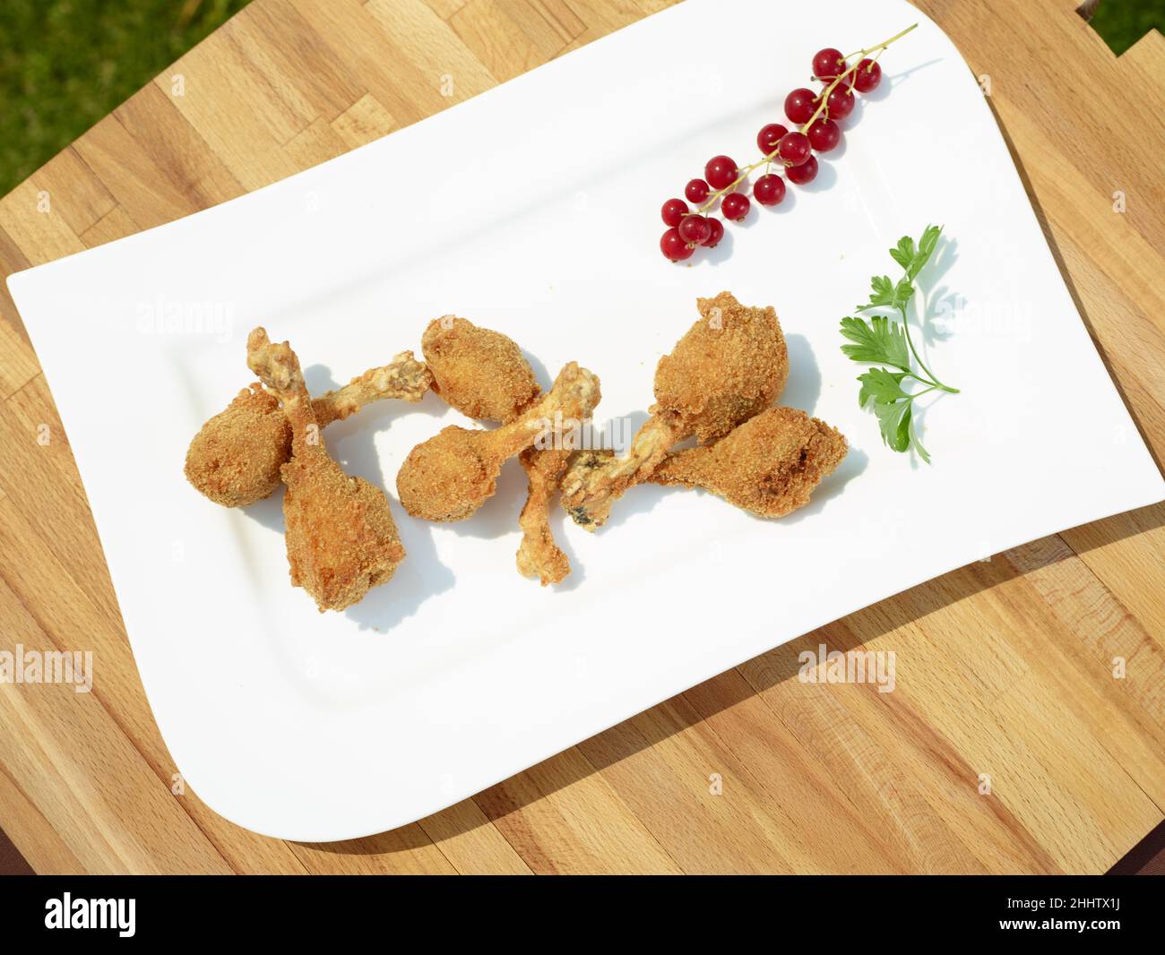 Quail legs fried with red fruits Stock Photo Alamy