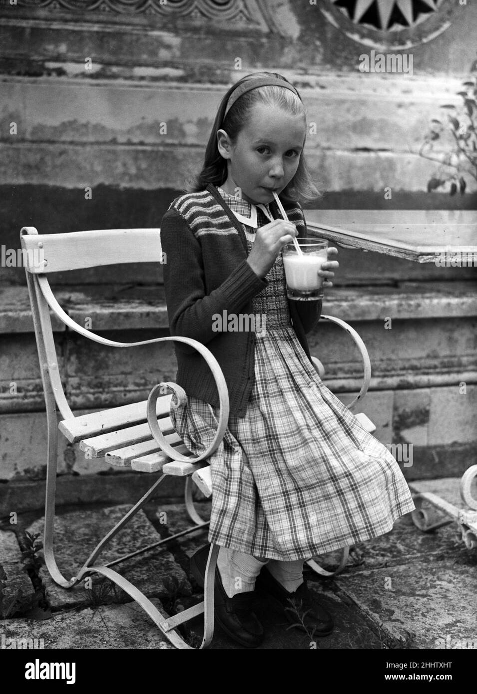 Actress Juliet Mills drinking milk at home. 17th August 1951. Stock Photo