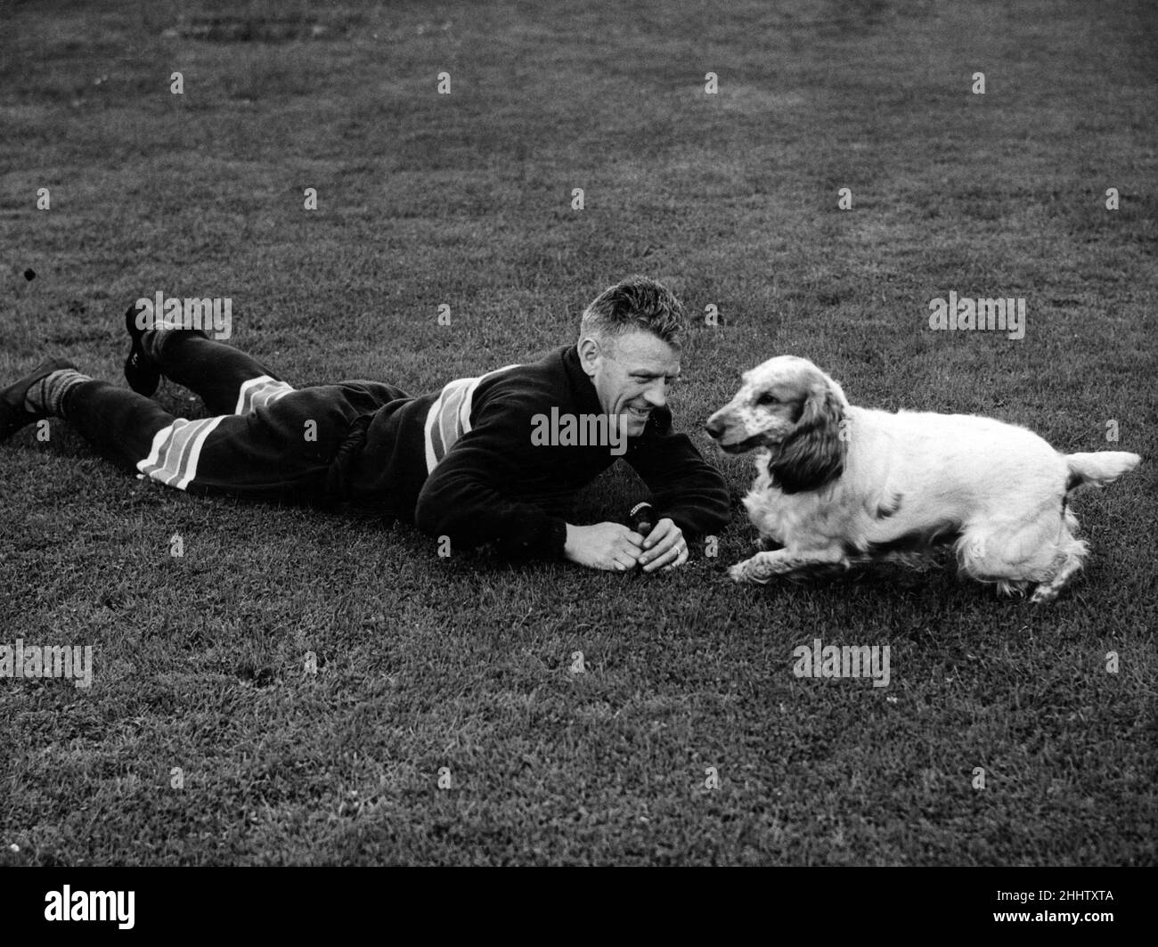 Jock Shaw had a wrestle with Sandy after training and the way he is getting off his mark proves the 'Tiger' won. 21st July 1953. Stock Photo