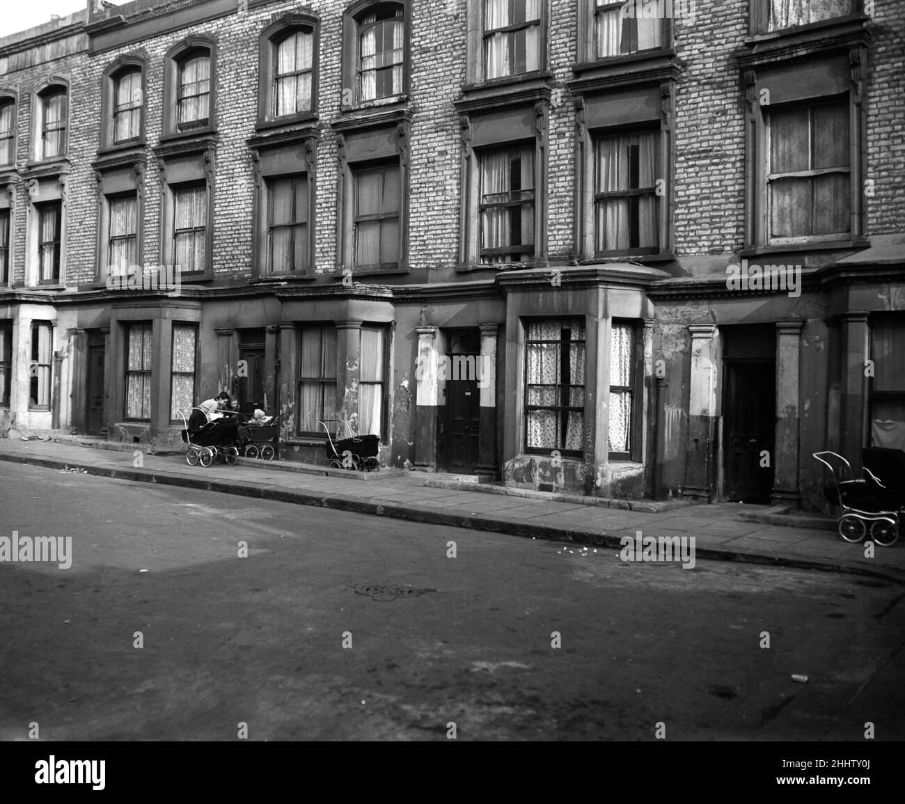 A general view of Rillington Place in west London where at Number 10 the bodies of four women were found. It was in this house that John Christie had lived and moved out of during March 1953, soon afterward the bodies of three of his victims were discovered hidden in an alcove in the kitchen. His wife's body was found beneath the floorboards of the front room. 25th March 1953. Stock Photo