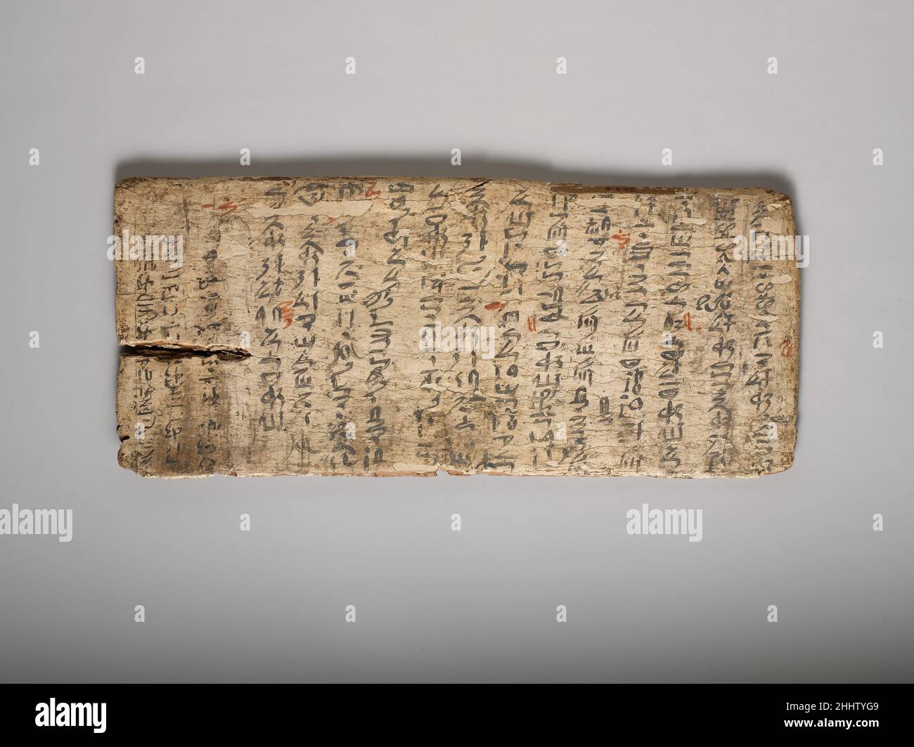 Writing board ca. 1981–1802 B.C. Middle Kingdom Gessoed boards were used for writing notes or school exercises. Like the slate writing tablets of yesteryear, they could be used repeatedly, with old texts being whitewashed to provide a “clean slate” for another. This board still bears traces of earlier writing (at left). The main text is a wordy model letter that the student copied—and surely also was expected to memorize. His many spelling mistakes have been corrected in red ink by the teacher.. Writing board. ca. 1981–1802 B.C.. Wood, gesso, paint. Middle Kingdom. From Egypt; Said to be from Stock Photo