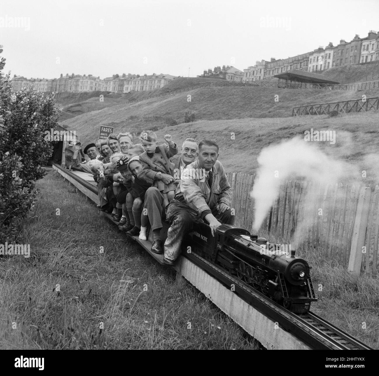 Holiday makers enjoying a ride on a miniature train. Scarborough, North Yorkshire. 11th August 1949. Stock Photo