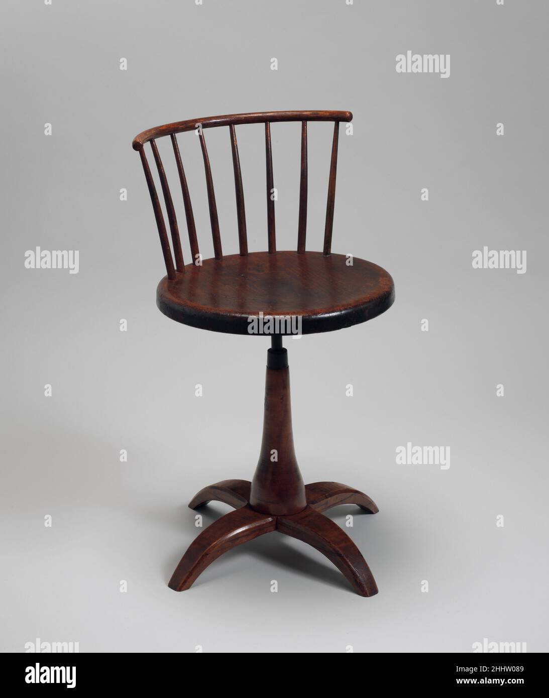 Revolving Chair 1840–70 United Society of Believers in Christ’s Second Appearing (“Shakers”), Mount Lebanon, New York Revolving chairs, also known as stools or swivel chairs, were produced by Shakers in many styles and sizes. The earliest examples stood on long legs and often were used in the brethren's shops. Low revolving chairs, such as this example, with Windsor-like comb backs were rarely made before 1840.. Revolving Chair  6861 Stock Photo