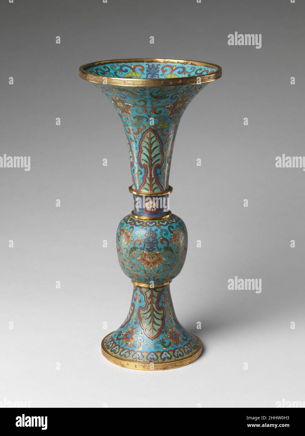 Vase from a Set of Five-Piece Altar Set (Wugong) 18th century China Cloisonné is the technique of creating designs on metal vessels with colored glass paste placed within enclosures made of copper or bronze wires, which have been bent or hammered into the desired patterns. Known as cloisons (French for 'partitions'), the enclosures are generally either glued or soldered onto the metal body. The glass paste, or enamel—which gets its color from metallic oxides—is painted into the contained areas of the design. The vessel is usually fired at a relatively low temperature, about 800 degrees Celsius Stock Photo
