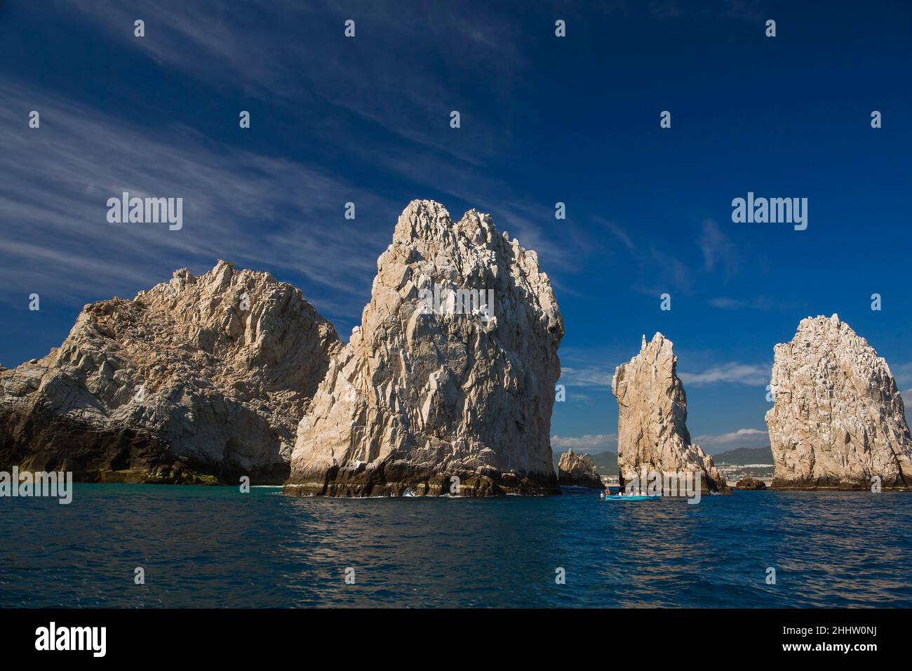 A glass bottom boat takes tourists around rock formations near the Arch in Cabo San Lucas, Baja California Sur, Mexico Stock Photo