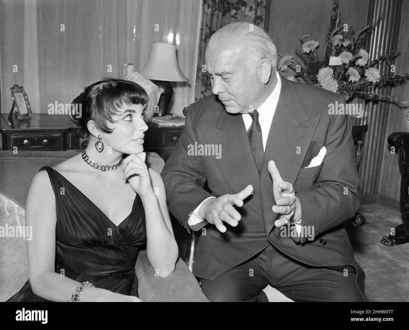 Joan Collins, actress, pictured at home, with family and friends, London, 4th October 1955. Pictured with Spyros Panagiotis Skouras, Greek American motion picture pioneer and movie executive who was the president of the 20th Century Fox from 1942 to 1962. Stock Photo