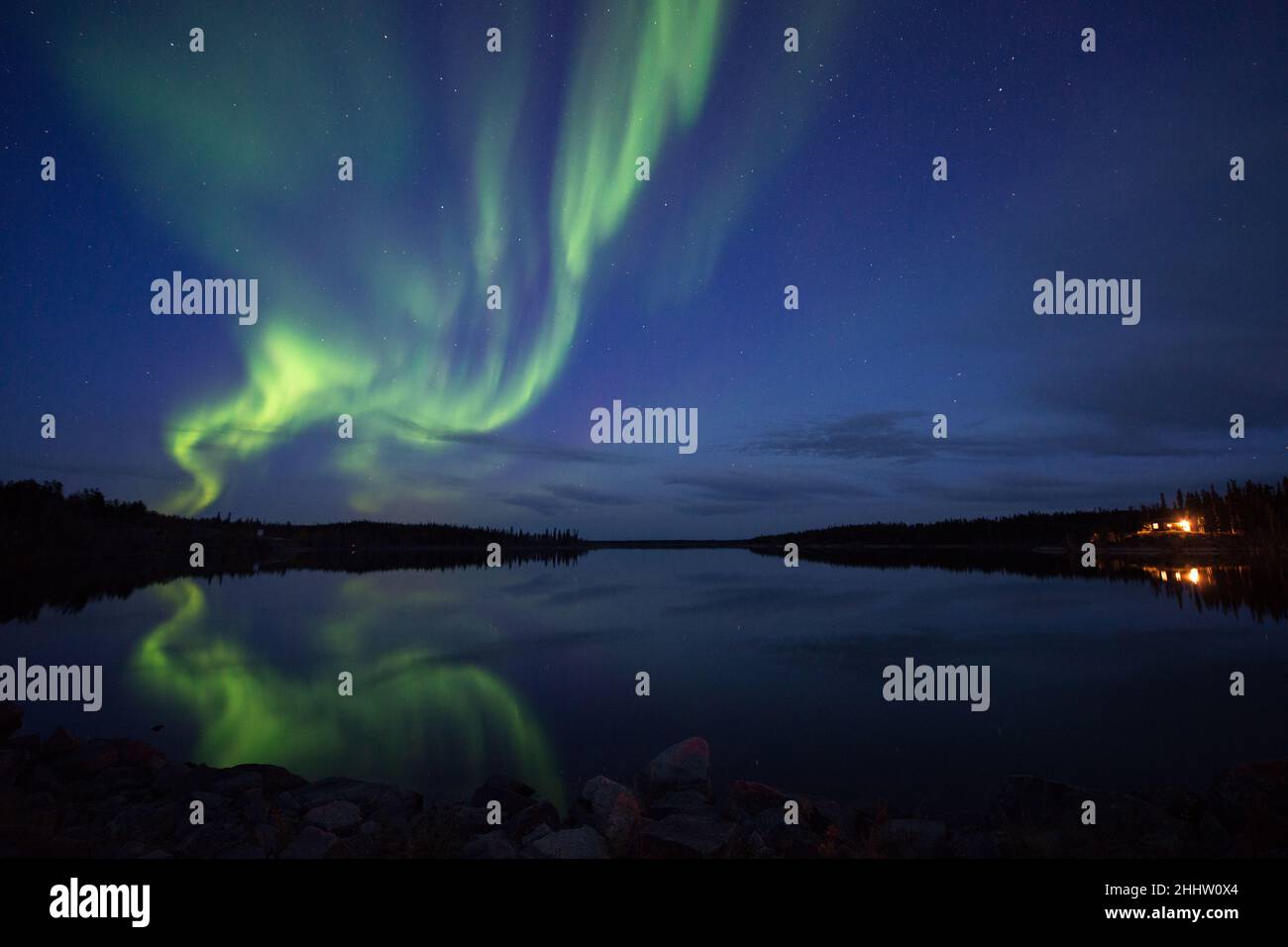 Bright Aurora Borealis (Northern lights) reflecting in lake and over ...