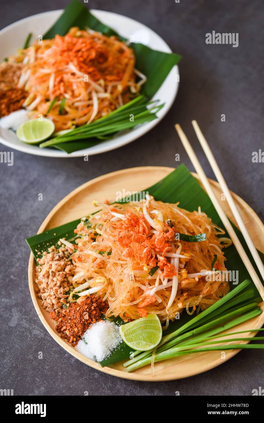 Thai food fried noodle Thai style with prawns bean sprout and garnish peanuts chili powder sugar