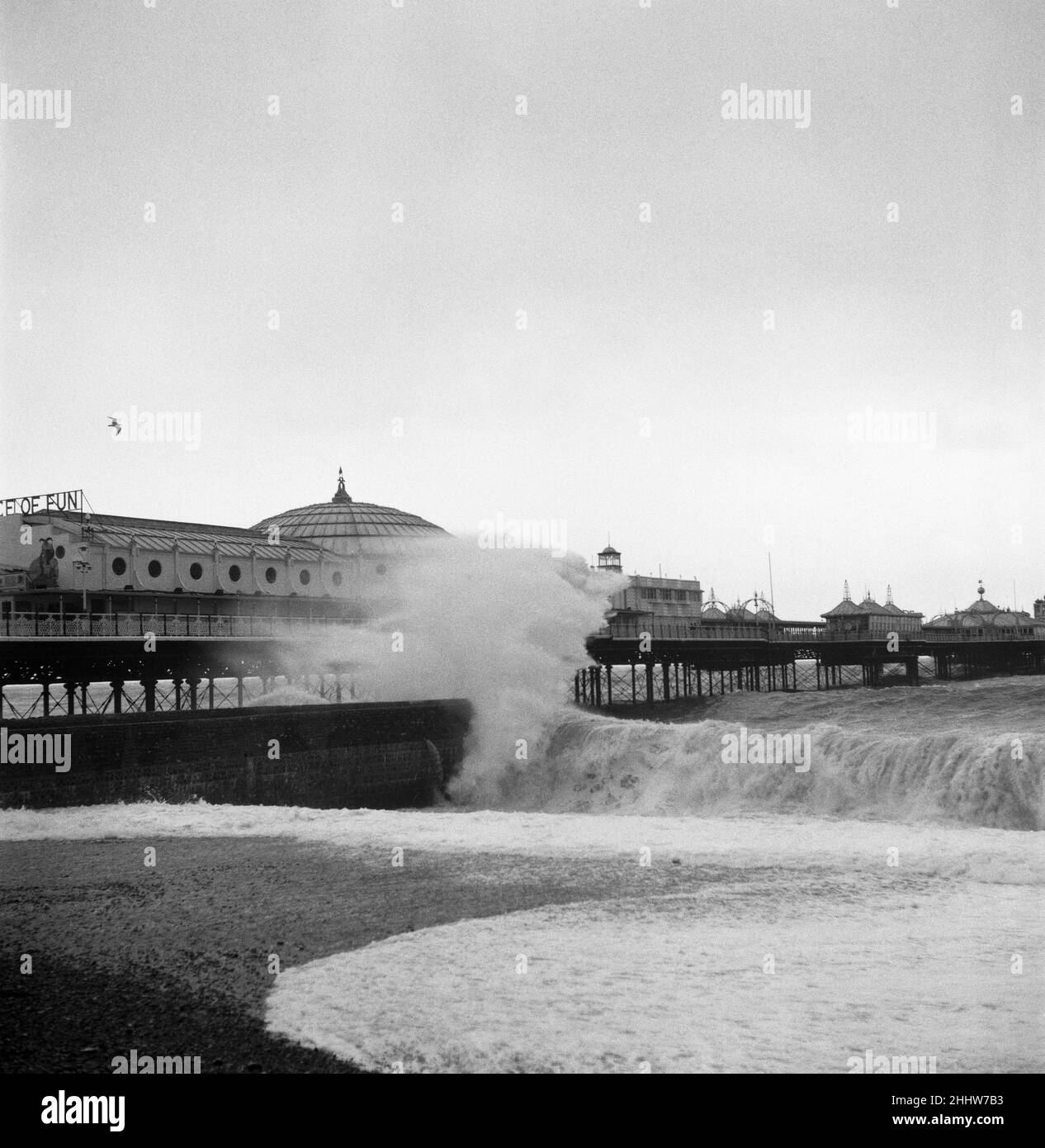 Gales at Brighton. A beautiful milky wave at Brighton, the pier can be seen in the background. Waves pounding the beach. 2nd May 1954. Stock Photo