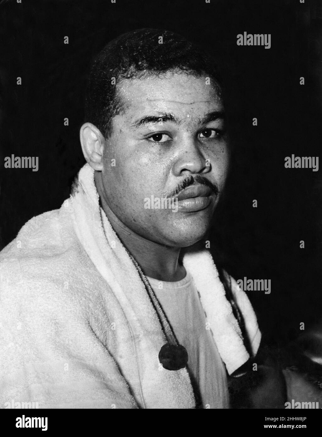 American  boxer Joe Louis, former heavweight champion of the world, takes a rest between bouts during the Arena of Sport exhibition held at Earls Court, London. 27th February 1948. Stock Photo