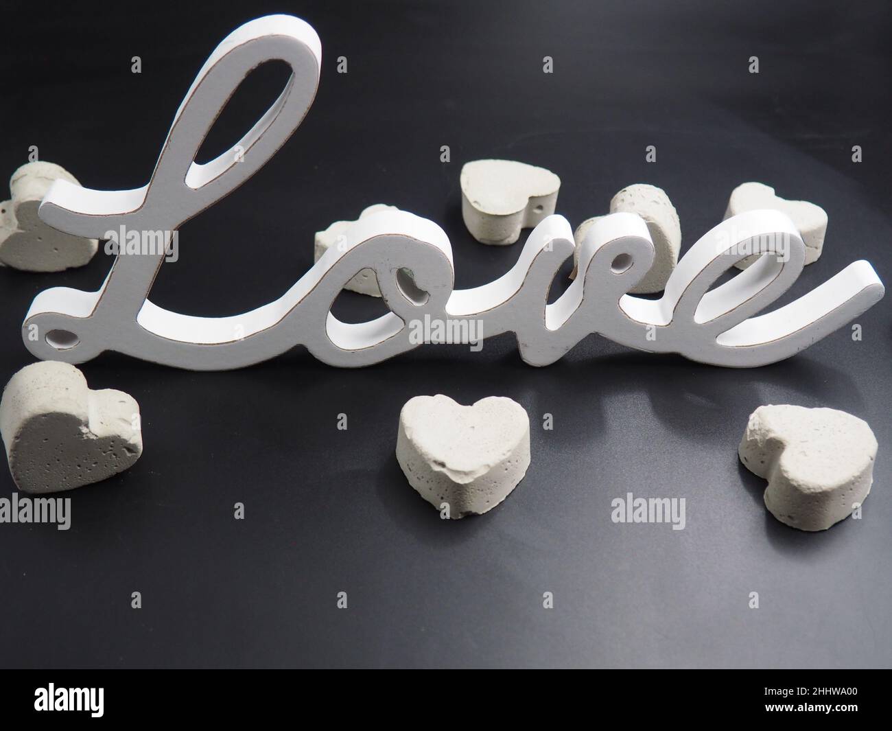 White wood love sign against black background Stock Photo