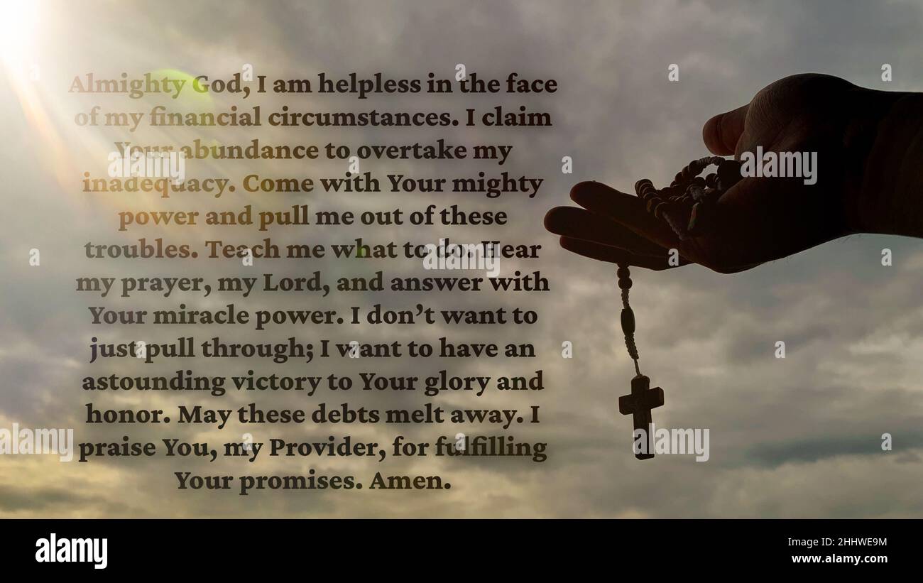 Christian prayer on financial abundance with bright light shining and hand holding Holy Rosary background. Prayer concept. Stock Photo