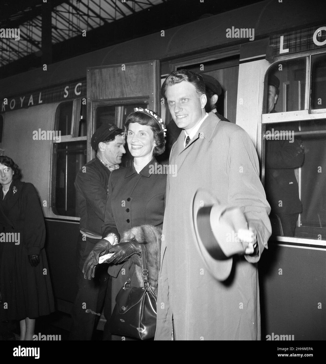 American evangelist Billy Graham arrives with his wife Ruth  at Euston Station in London after his successful Scottish Crusade. 11th May 1955. Stock Photo