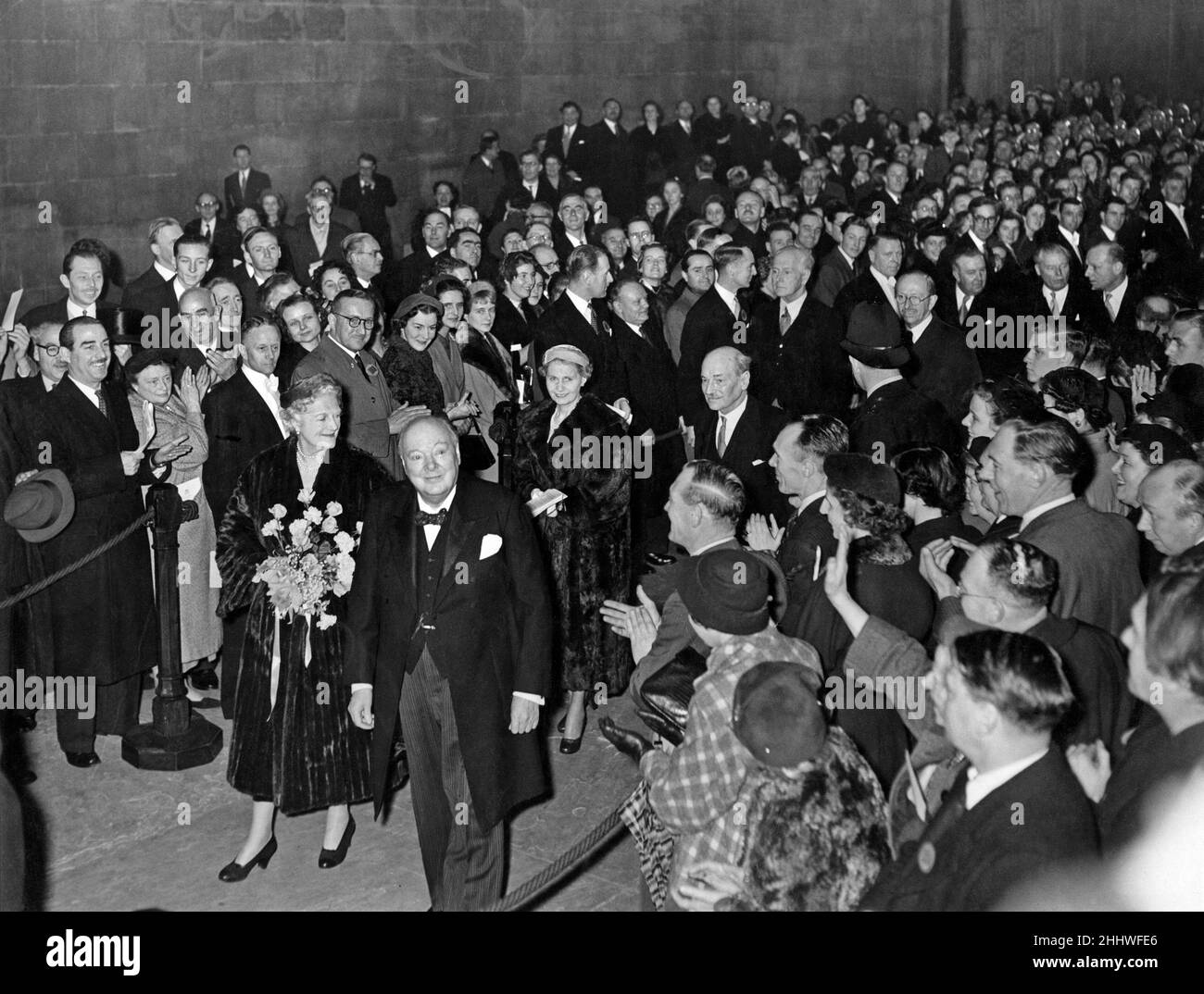 Prime Minister Winston Churchill  receives a birthday presentation in Westminster Hall on his 80th birthday by Clement Attlee, leader of the Opposition.The gift was was a portrait of Sir Winston painted in oils by Graham Sutherland, a joint gift of the Lords and the Commons. Here Sir Winston leaves the hall with Lady Churchill after the presentation.  30th November 1954. Stock Photo