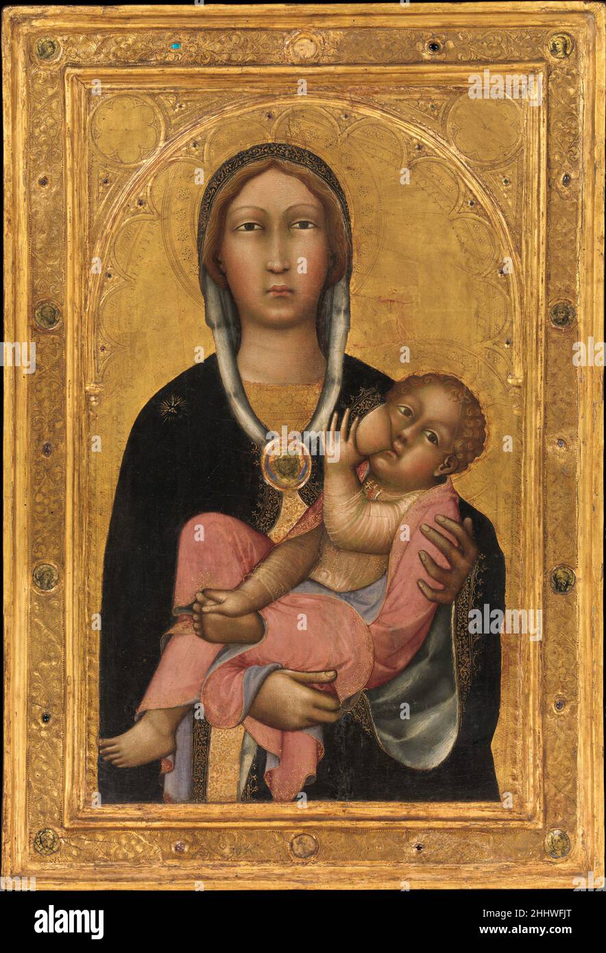 Madonna and Child 1370s Paolo di Giovanni Fei Italian This independent panel of the Madonna nursing her child is among the masterpieces of fourteenth-century Sienese painting. It transforms a common, maternal activity into an icon of devotion and is painted with Fei's special feeling for decorative richness and technical refinement. The engaged frame is original, as are the gold-backed, glass medallions with images of the Annunciation, saints, and the head of Christ—a technique known as verre églomisé. The picture may originally have stood on an altar or hung in a domestic interior.. Madonna a Stock Photo