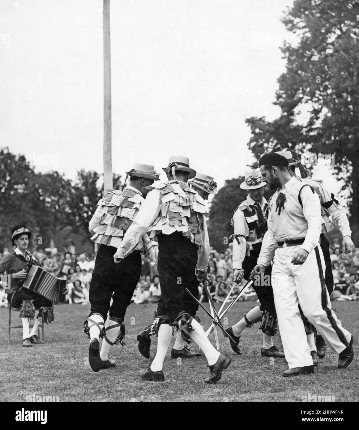 The Old English Folk Dance Society performing the sword dance at Stratford Upon Avon. Musical accompaniment provided by the accordion. West Midlands. 2nd August 1948 Stock Photo