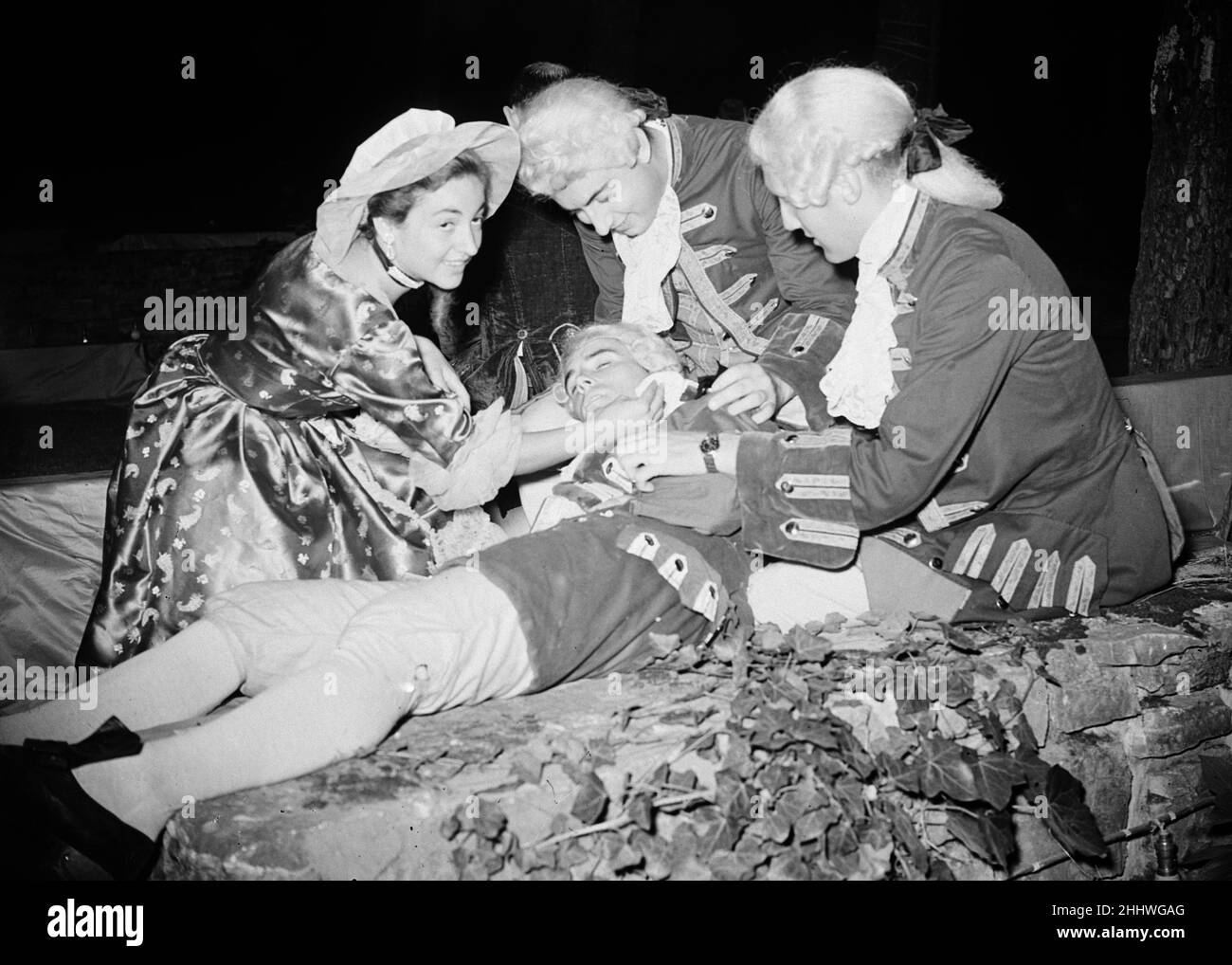 Costume ball hosted by George de Cuevas in Biarritz, France, Tuesday 1st September 1953. Our Picture Shows ... a lackey who collapsed during the ball, receives medical attention. Stock Photo