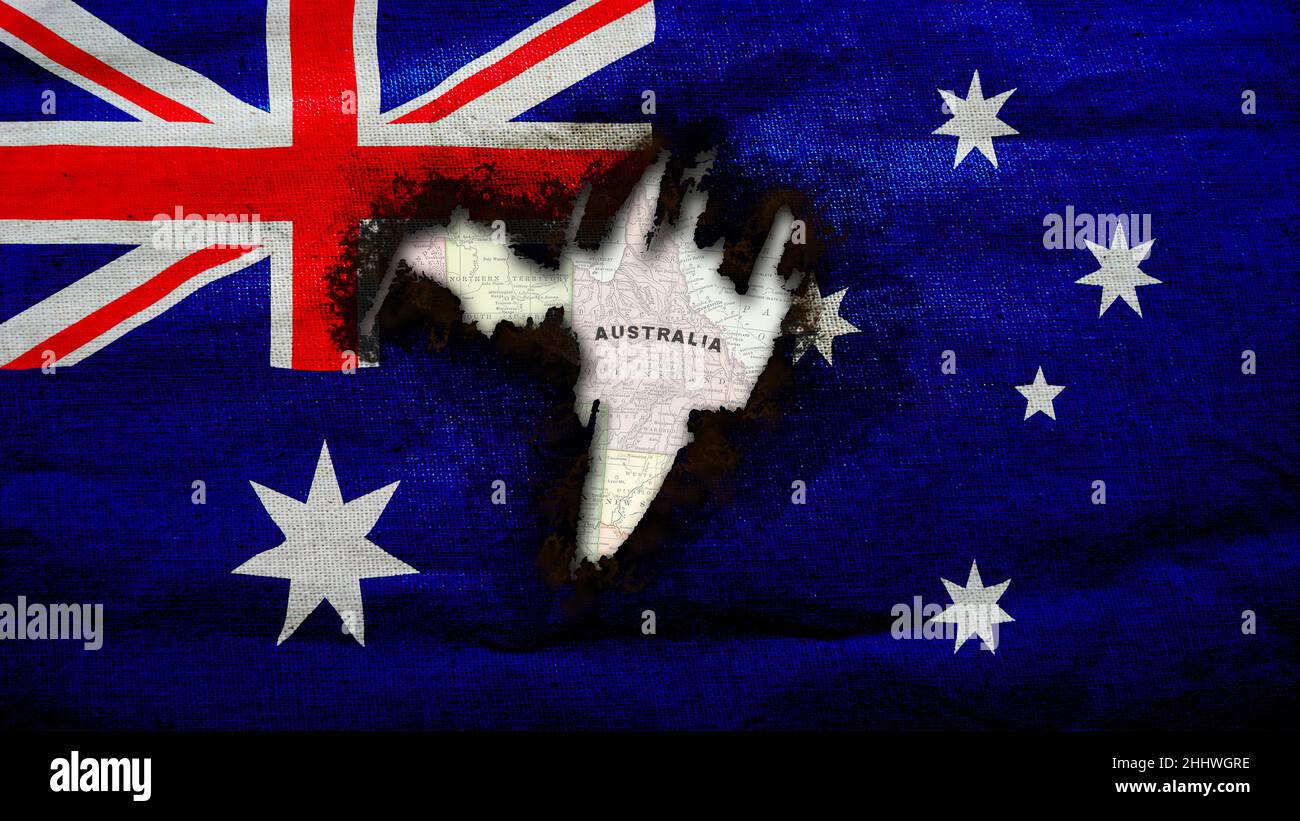Australian Flag with burnt hole revealing vintage map of Australia Stock Photo