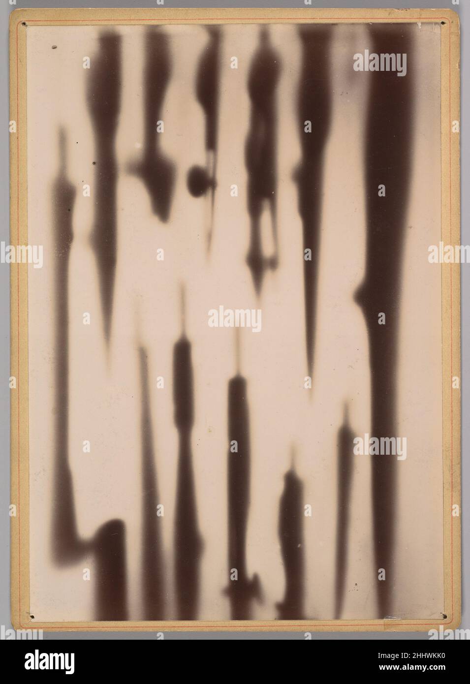 [X-Ray of a Box Compasses and Drawing Tools] 1896 Dr. Henri van Heurck Belgian Shadows streak across an incandescent field, their silhouettes resisting recognition. Though nearly abstract, this image is no modernist exercise in form, but rather an early X-ray showing compasses and drawing tools inside of a closed box. Created within months of the X-ray’s discovery, it is one of the preliminary radiographic experiments recorded by the Belgian scientist Dr. Henri van Heurck, who had begun using fluorescent screens during this period to make X-rays with shortened exposure times. When he published Stock Photo