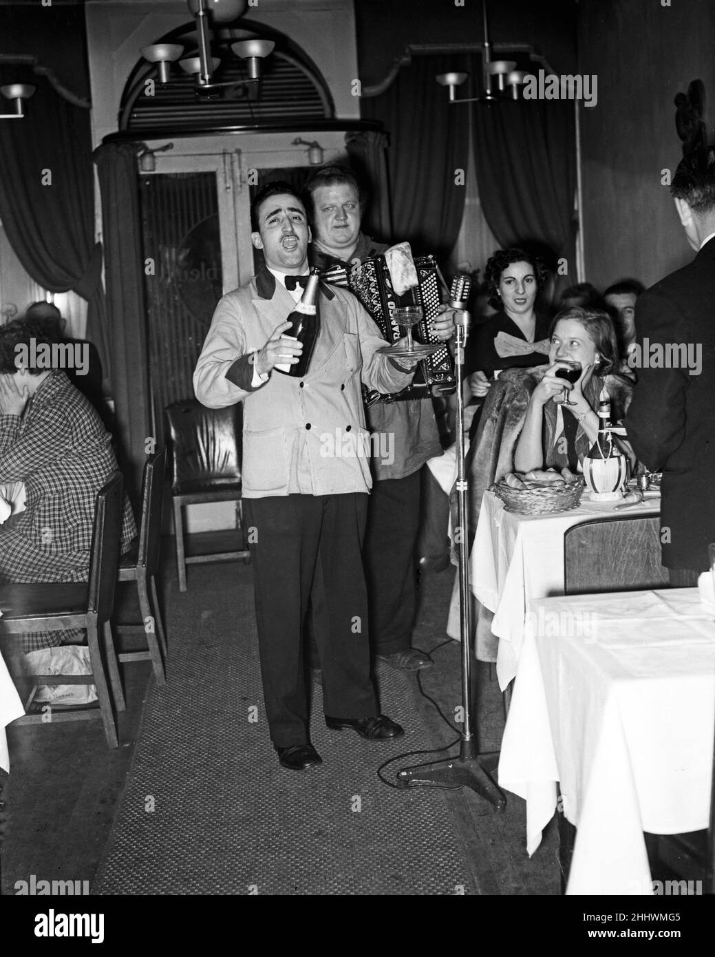 Scenes at Cafe Bleu restaurant in Soho, London.Musicians playing to customers seated at their tables. 1st November 1951. Stock Photo