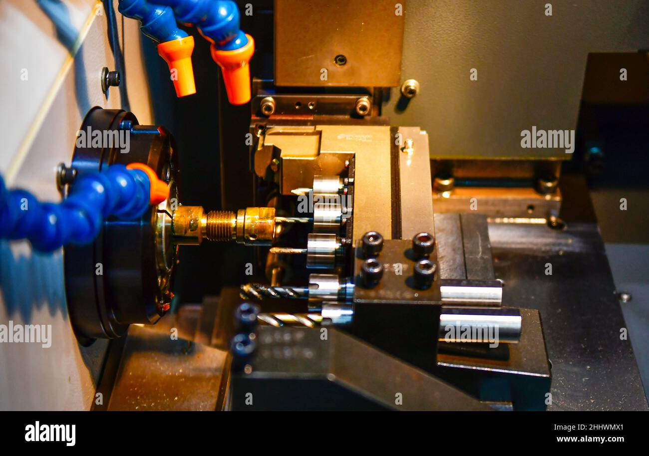 The multi-tasking CNC lathe machine hi-technology metal working process with turning machine control by computer program at industrial Stock Photo
