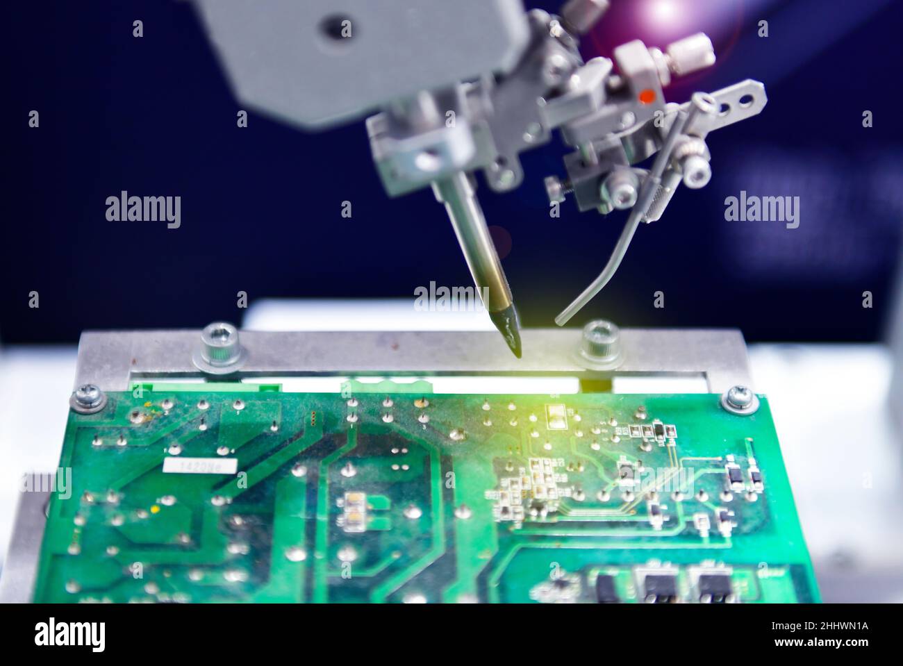 High technology and modern automatic robot for print circuit board (PCB)assembly machine during soldering or welding part or component at factory Stock Photo