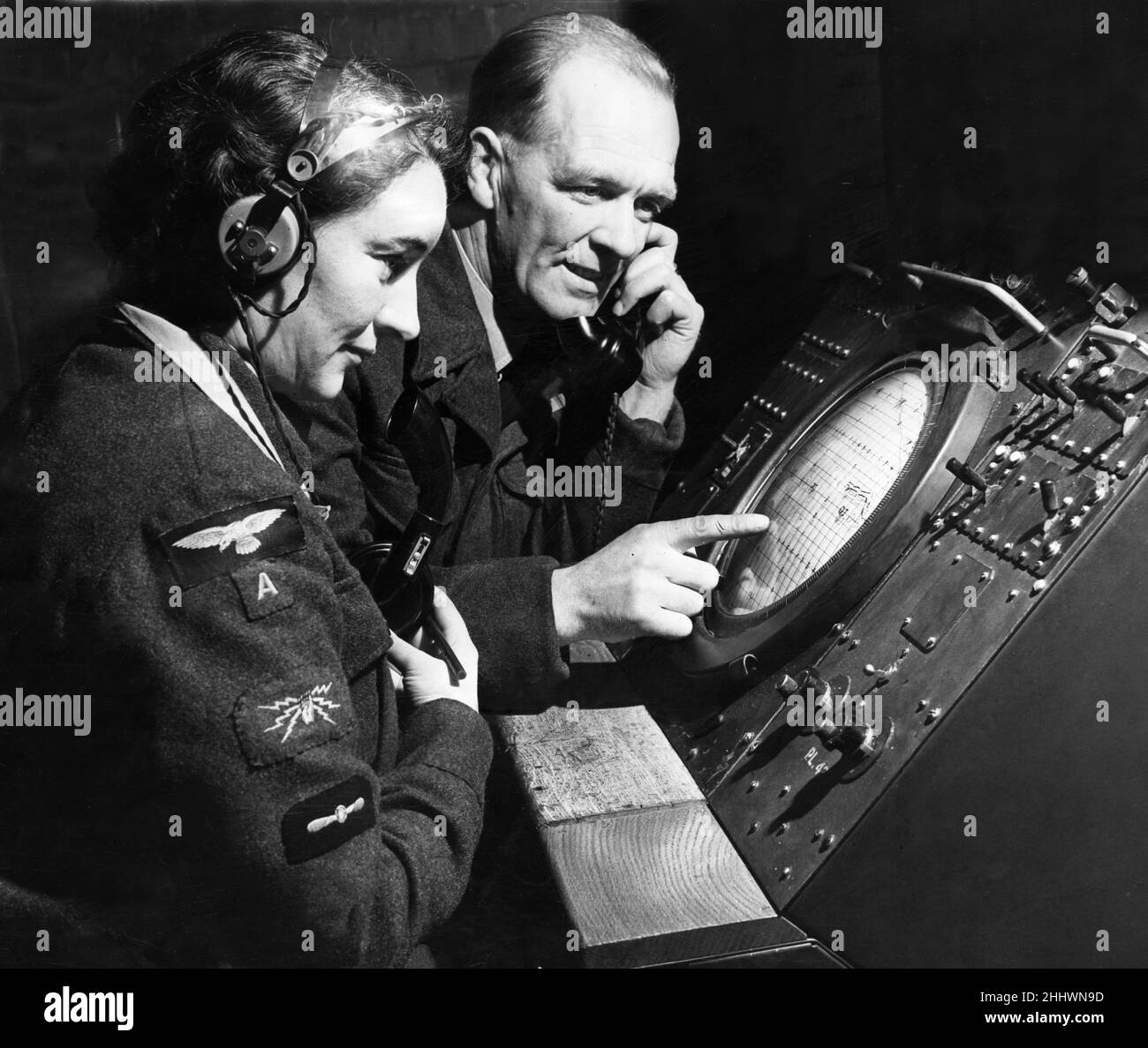 Royal Auxiliary Air Force Flying officer Eric Lloyd of Eccleston and LACW Peggy Hughes of Tottington, Bury keep track of an invader on  a radar screen at 3613 Fighter Control Unit at Bowlee.11th February 1955. Stock Photo