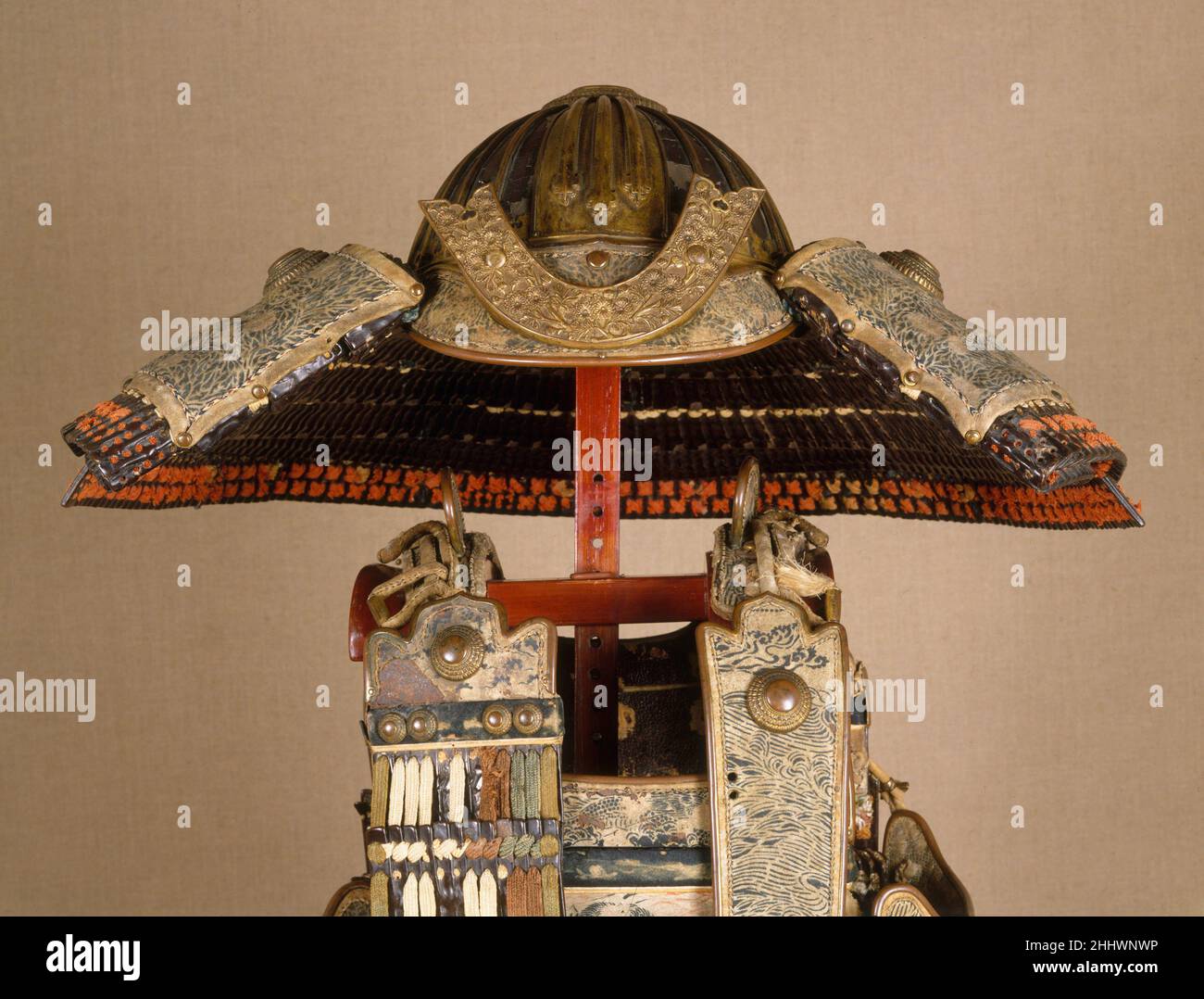 Helmet of Ashikaga Takauji (1305–1358) mid-14th century Japanese This helmet is part of a rare example of a medieval yoroi. The yoroi is characterized by a cuirass that wraps around the body and is closed by a separate panel (waidate) on the right side and by a deep four-sided skirt. In use from around the tenth to the fourteenth century, yoroi were generally worn by warriors on horseback.Originally, this armor was laced in white silk and had diagonal bands of multicolored lacings at the edges of the skirt and the sode (shoulder guards, missing here). The colored lacings symbolized the rainbow Stock Photo