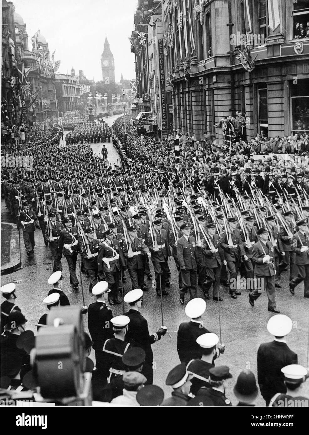 The armed service march along Whitehall after the Coronation of Queen Elizabeth II  at Westminster Abbey. The Contingent of the Royal Navy and Royal MarinesThe Officer Commanding the Contingent, Captain V. C. Begg, D.S.O., D.S.C., R.N. With detachments from: Royal Marines and Royal Marines Forces Volunteer Reserve. Followed by First Detachment of the Foot Guards The Officer Commanding the First Detachment, Lieut-Colonel B. O. P. Eugster, D.S.O., M.C., Irish Guards leading the Band of the Welsh Guards, Band of the Irish Guards, The Corps of Drums of the 1st Bn. Welsh Guards and the Corps of Dru Stock Photo