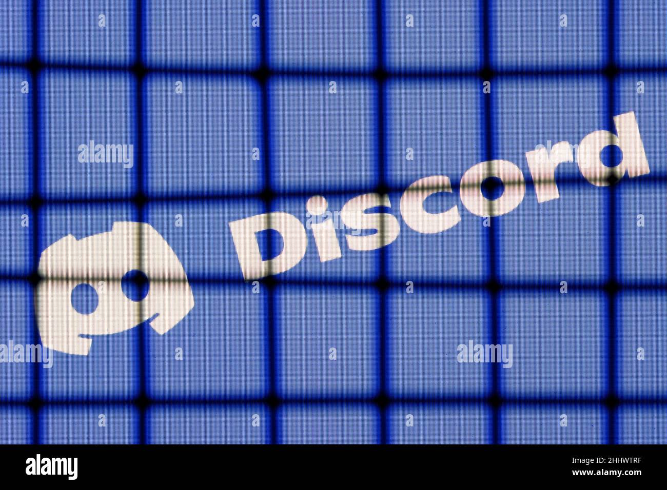 The logo of the Discord social gaming platform behind bars. The concept of Discord censorship and prohibition. Stock Photo