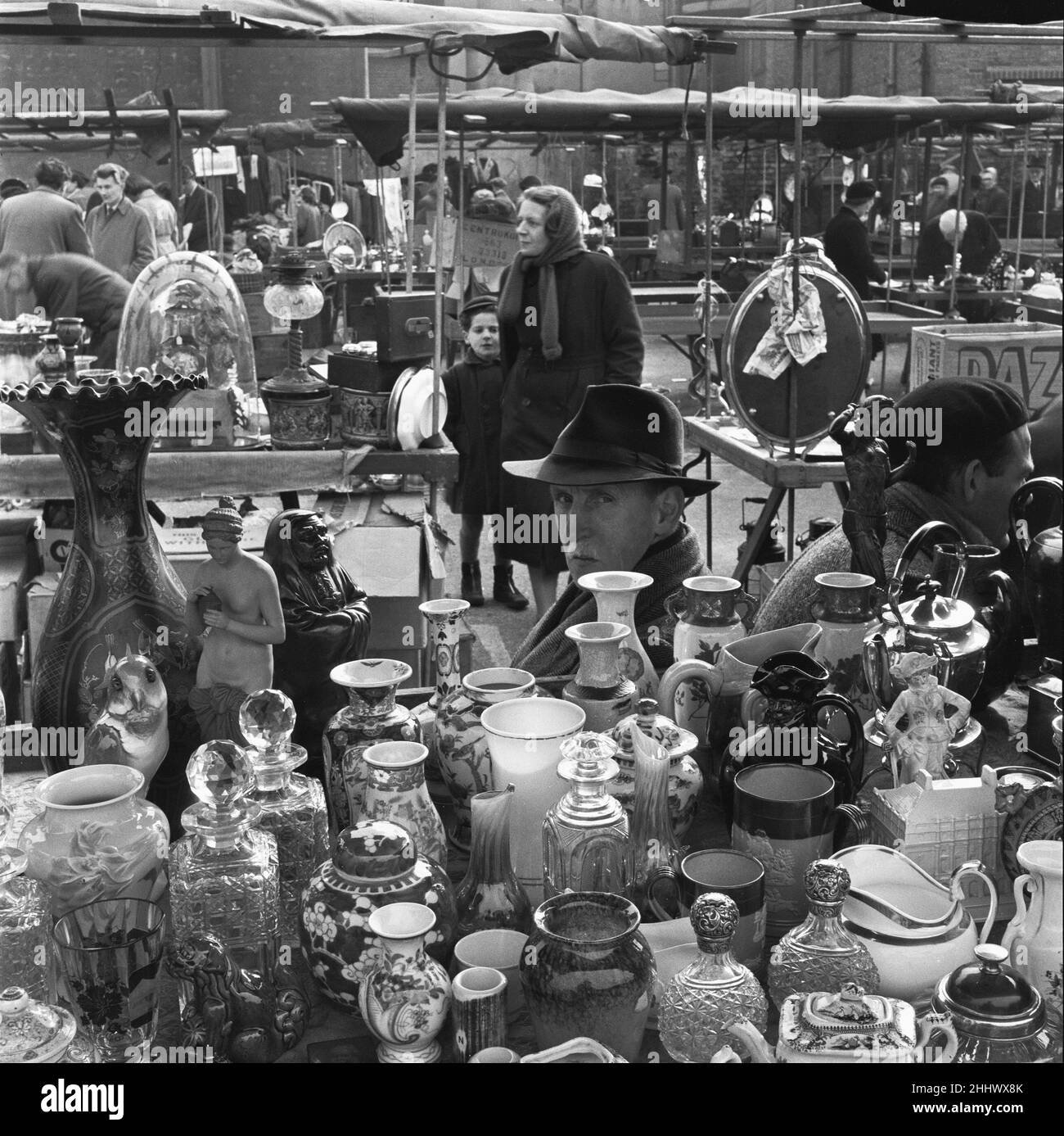 Antique dealer and his stall at the New Caledonian Street Market. 22nd March 1954 Stock Photo