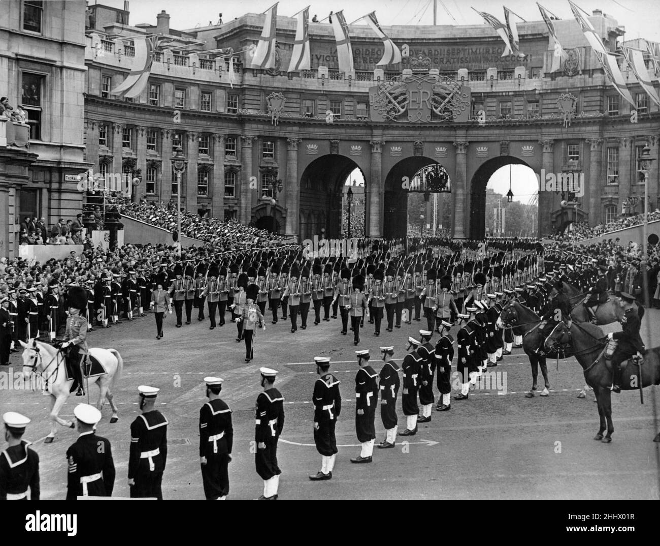 Her Majesty's Procession approaches Trafalgar Square led by Colonel B. J. O. Burrows, O.B.E., T.D. and Five Companies of the Foot Guards as they escort the Queen's coach to Westminster Abbey for her Coronation. 2nd June 1953 Stock Photo