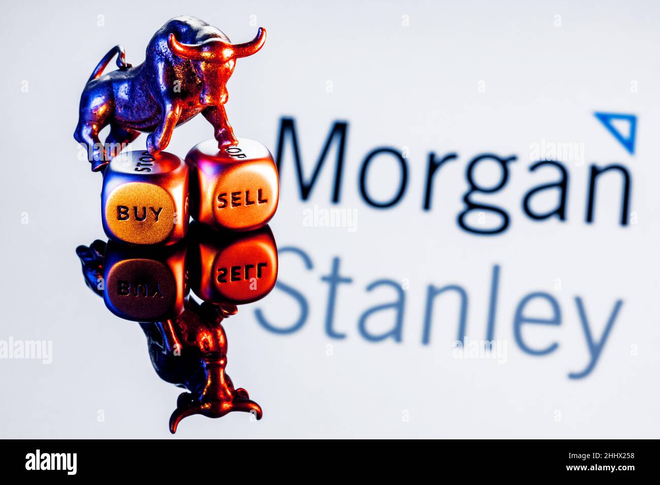 Metal bull stands on buy-sell dices on background of Morgan Stanley bank logo Stock Photo